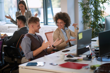 colleagues talking, smiling, explaining with hands, gesticulate in modern open space office. indoor, open space, modern, casual, office, business