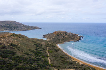 Ghajn Tuffieha, Malta - Aerial panoramic view of the coast of Ghajn Tuffieha with Gnejna Bay, Riviera Bay and Golden Bay at sunrise