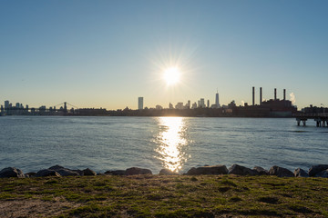 Shore of Transmitter Park in Greenpoint Brooklyn New York along the East River with a view of the Manhattan Skyline before Sunset