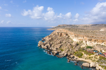 Fototapeta na wymiar Aerial view of tourist attraction Popeye village, also known as Sweethaven village. Sunny day, blue sea. Mellieha city. Malta