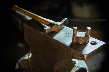 A hammer on the anvil in natural lighting indoors