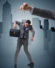 Businessman puppet being manipulated by boss