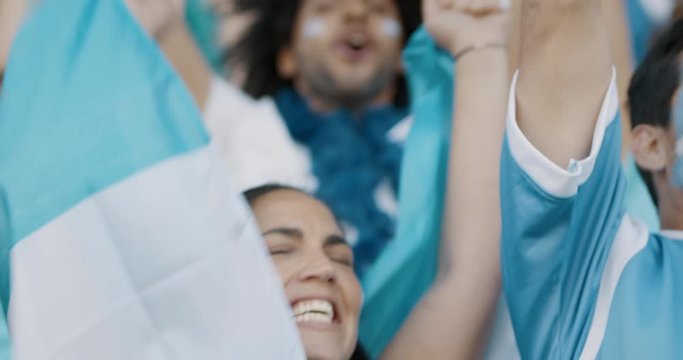 Soccer fans cheering for national team at the stadium