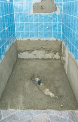 A shower cabin with new concrete flooring during a bathroom renovation modernization project 