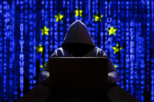 Cyber threat from Europe. European hacker at the computer, on a background of binary code, the colors of the flag of the European Union. DDoS attack