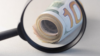 part of dollars under a magnifying glass, closeup.