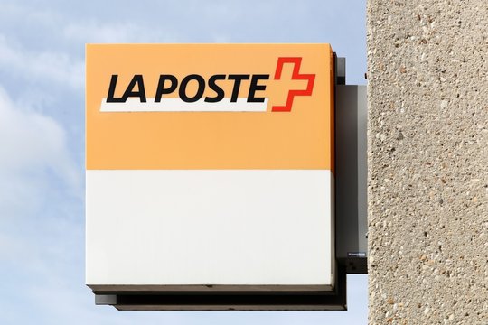 Versoix, Switzerland - October 1, 2017: La poste logo on a wall. Swiss post is the national postal service of Switzerland and a public company 