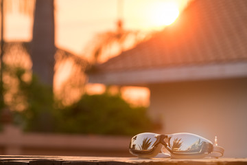 Swimming goggles on the wooden with the sunlight twilight