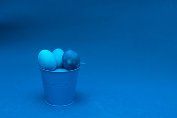 classic blue easter eggs in bucket