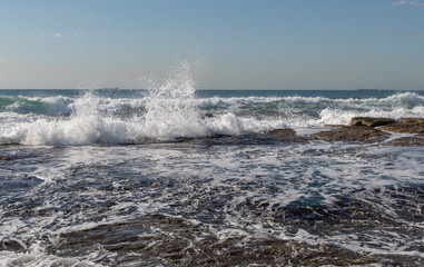 waves crashing on rocks