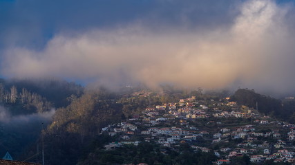 Sunset over houses on hill in Funchal, Madeira, Portugal timelapse