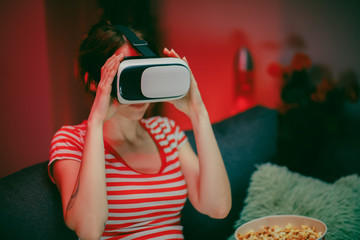 Woman wear VR headset playing video game. Woman relaxing playing video games using vr headset. Caucasian female gamer.