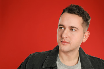 Portrait of young man on red background