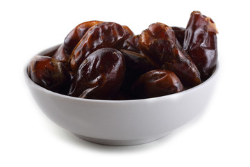 Date fruits on saucer isolated on white