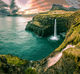Sunset over the village of Gasadalur and waterfall at Vagar Island, Faroe Islands 