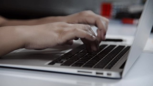 Closeup of typing on laptop