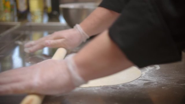 Restaurant kitchen - making a flat piece of dough