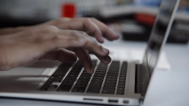 closeup of typing on laptop