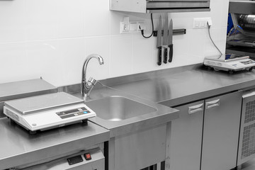 Design of the working area of the commercial cafe kitchen with stainless steel equipments, hot...