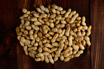 Peanuts on a dark background. Peanuts in the shell. Healthy food.