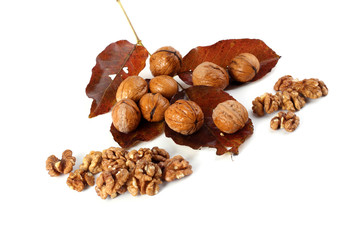 Walnuts and peeled walnuts on autumn leaves