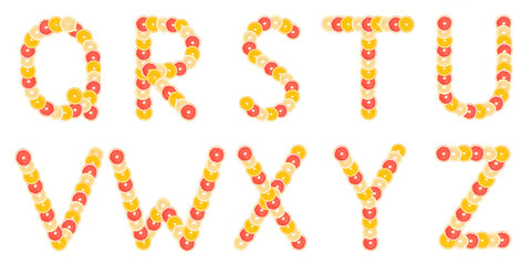 Alphabet made from sliced citrus fruits. Oranges, grapefruits. Isolated on a white background.