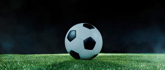 Football on an illuminated sports field at night