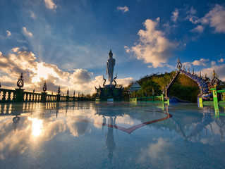 Photo of the big standing buddha statue in buddhist temple of Thailand.
