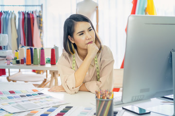 Portrait of female fashion designer thinking and working about her work. Start up. Business ideas concepts.