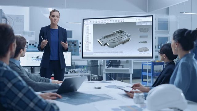 Modern Industrial Factory Meeting: Confident Female Engineer Uses Interactive Whiteboard, Makes Report to a Group of Engineers, Managers Talks and Shows 3D Mechanical Component made in CAD Software