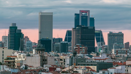 Fototapeta na wymiar Madrid Skyline at sunset timelapse with some emblematic buildings such as Kio Towers