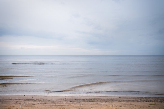 Minimal Seascape At Dusk. Neutral Background With Water In Blue Color Shade. Gulf Of Riga In Summer