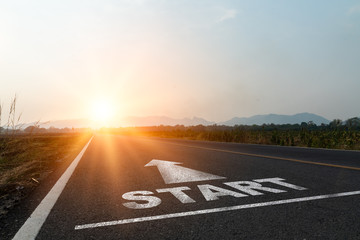 Concept of start straight and beginning for cooperation.Start text on the highway road concept for planning and challenge or career path,business strategy,opportunity and change in sunset background. - obrazy, fototapety, plakaty