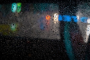 Rain drops on the windshield of a car at night