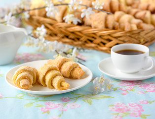 Three croissants on a table with spring flowers