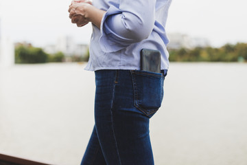 Woman wearing big phone in pocket