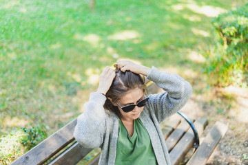 Woman fixing hair outside