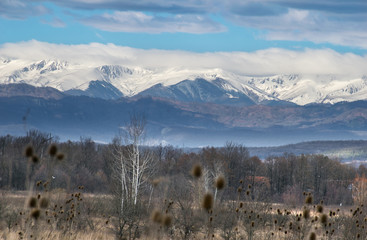 Beautiful mountain landscape. Snow covered mountains photographed from a distance. Somewere in...