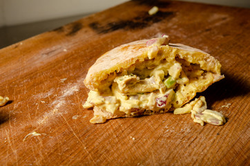 Cypriot pie chicken sauce wood background