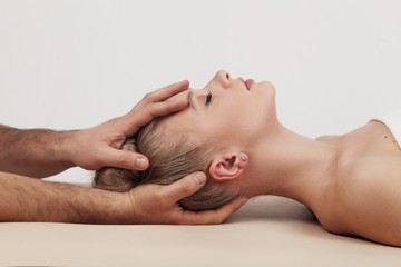 Fototapeta na wymiar Massage of the head and cervical spine with an osteopath