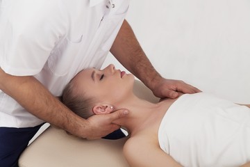 Fototapeta na wymiar Massage of the head and cervical spine with an osteopath