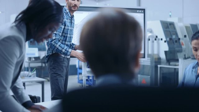 Modern Factory Office Meeting Room: Busy Diverse Team of Engineers, Managers and Investors Talking at Conference Table, Use Interactive TV, Analyze, Find Solutions, Discuss Concepts. Slow Motion
