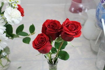trio of red roses