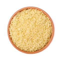 Parboiled rice pile in clay pot isolated on white background, top view