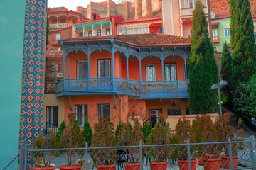 Fototapeta premium residential buildings with traditional carved wooden balconies on the rock of Tbilisi, Georgia