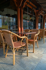 outdoor terrace of a coffee shop with rattan furniture