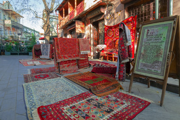 Tbilisi, Georgia, 18 December 2019 -  vintage style Oriental carpets stacks on a street carpets...