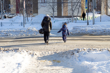a woman with a child crosses the road unsafe