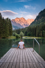 Man on landing stage, lake Planšarsko jezero, Kamnik-Savinja Alps