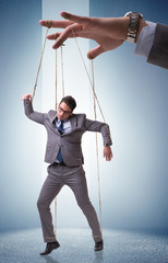 Businessman puppet being manipulated by boss